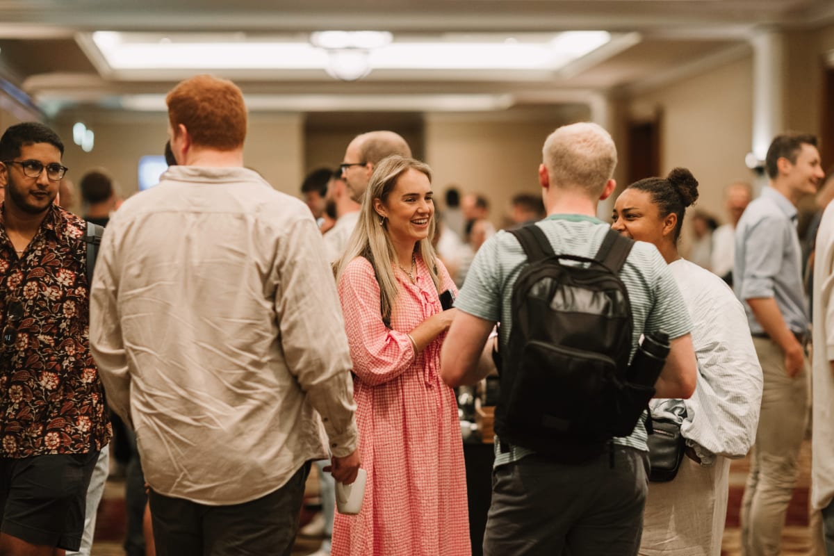 A group of graduates chatting in a room